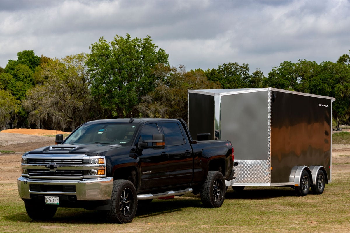 Black Truck Parked With Enclosed 8.5 Wide UTV Trailer On Grass