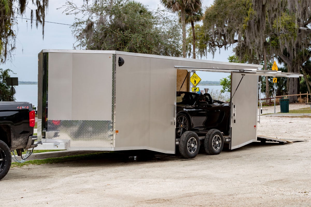 Parked Enclosed Supreme Car Hauler With Open Side-Door And Rear-door