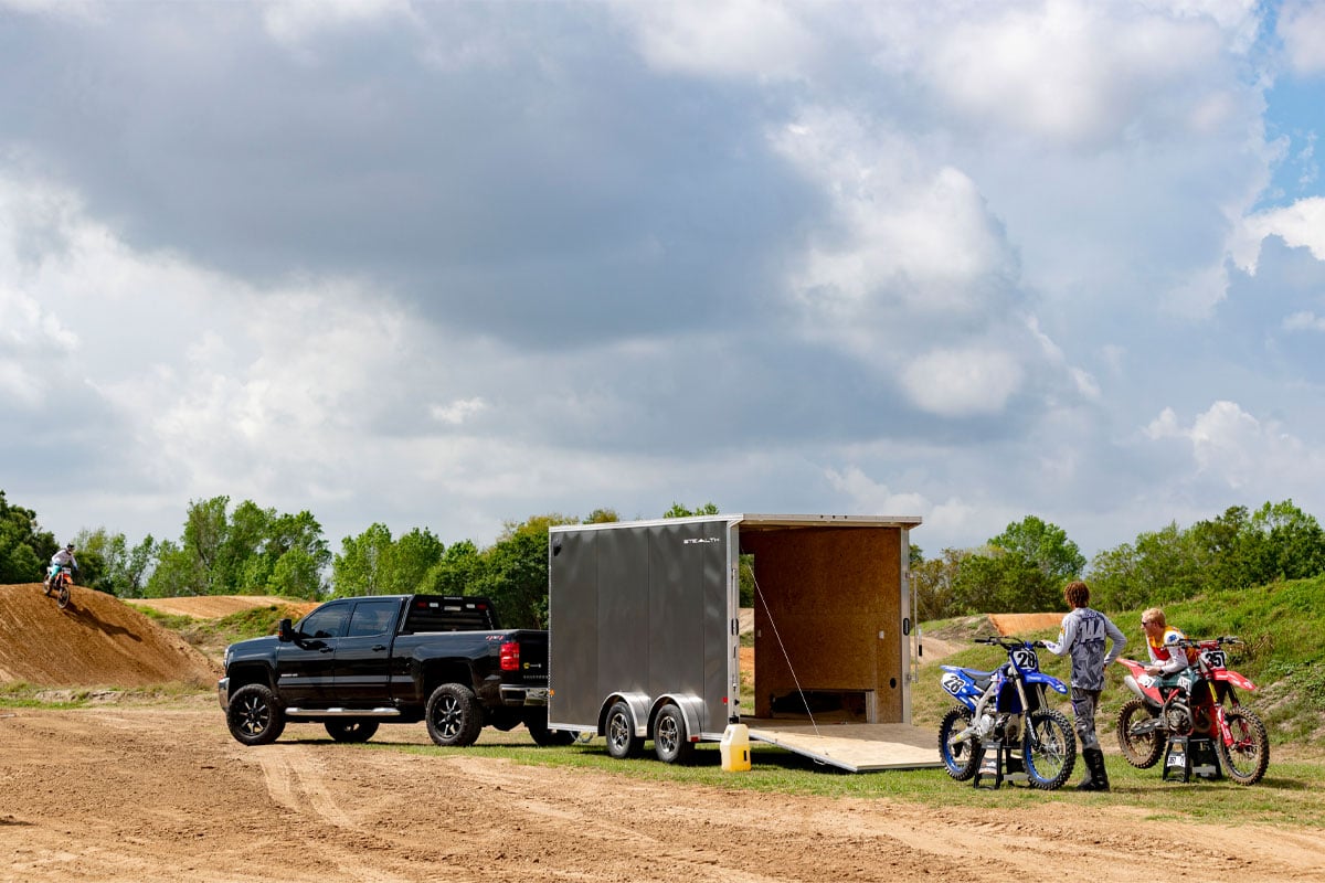 Unloading Dirt Bikes Off Of Enclosed 8.5 Wide UTV Trailer on Dirt